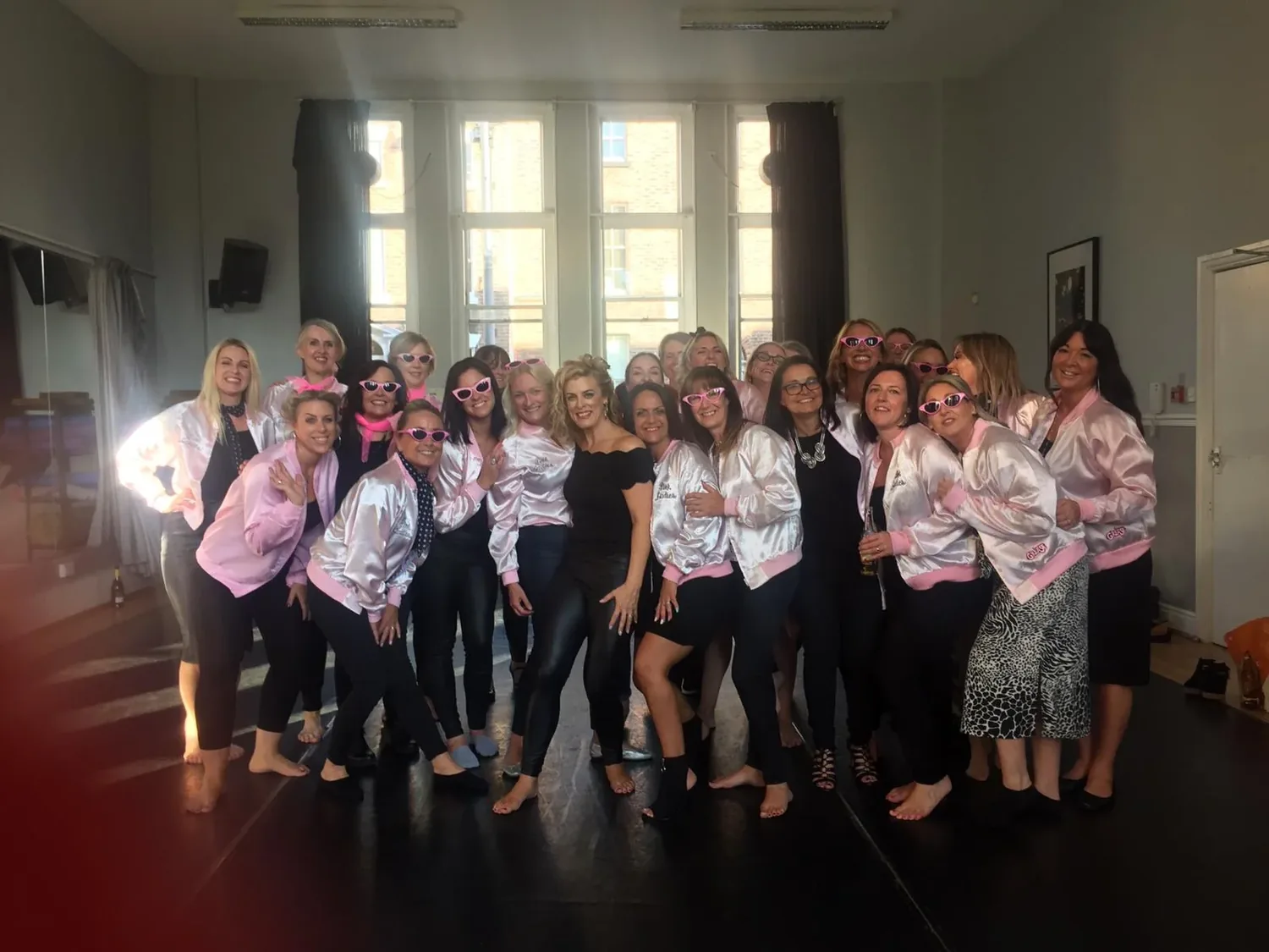 Grease hen party dance class in Nottingham, group in leather jackets mid-routine